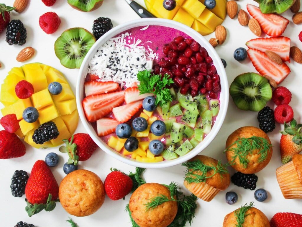 pexels-photo-1092730-1092730 Vibrant smoothie bowl topped with assorted fresh fruits and muffins, perfect for a healthy snack.